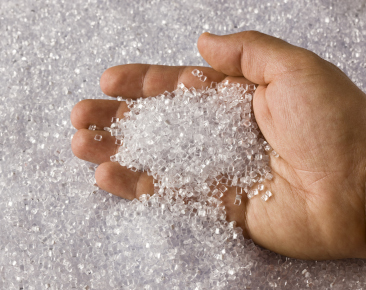 Plastic Clear Resin Pellets in a Holding Hand